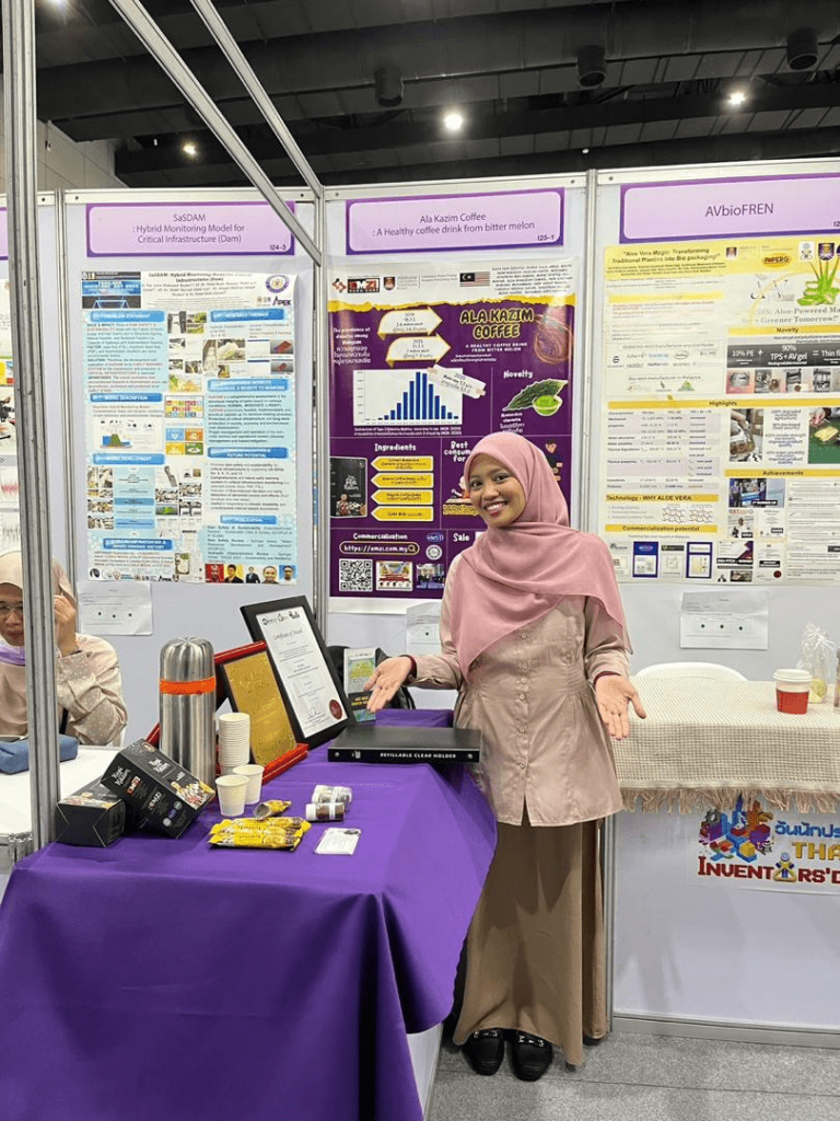 IPITEX 2024: A team member presenting beside the Ala Kazim Coffee poster