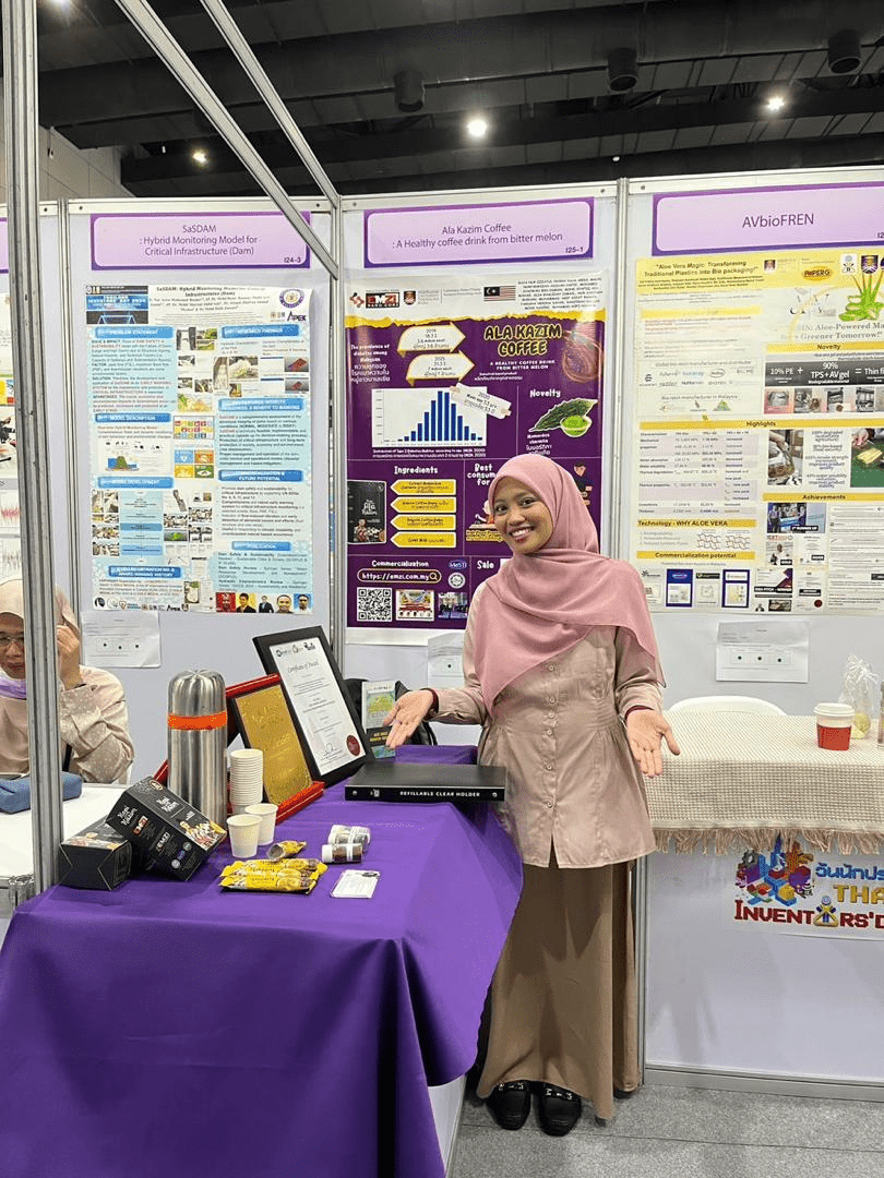 IPITEX 2024: A team member presenting beside the Ala Kazim Coffee poster