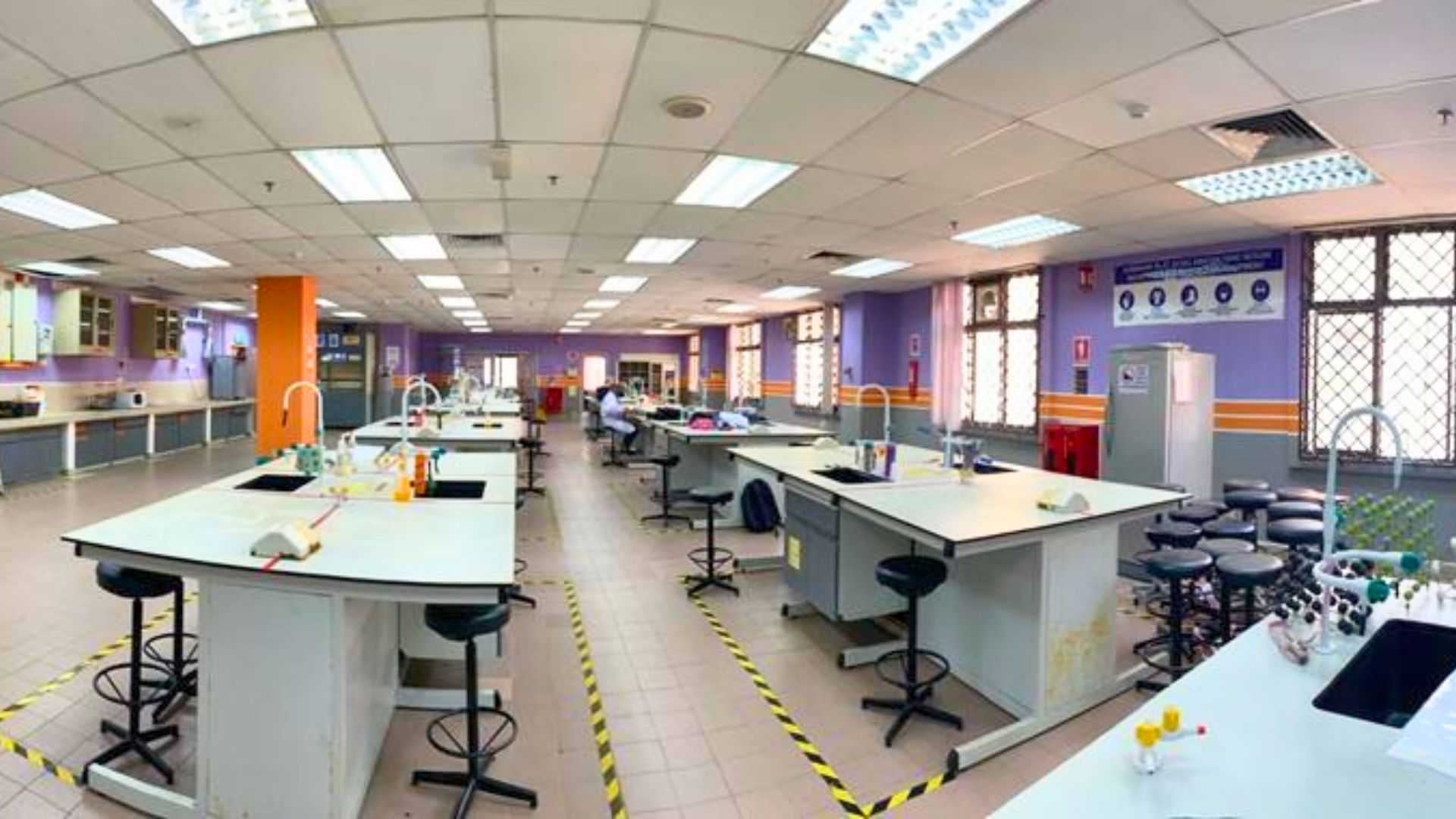 Interior of the EMZI NANO-CORE laboratory with white benches, stools and sinks