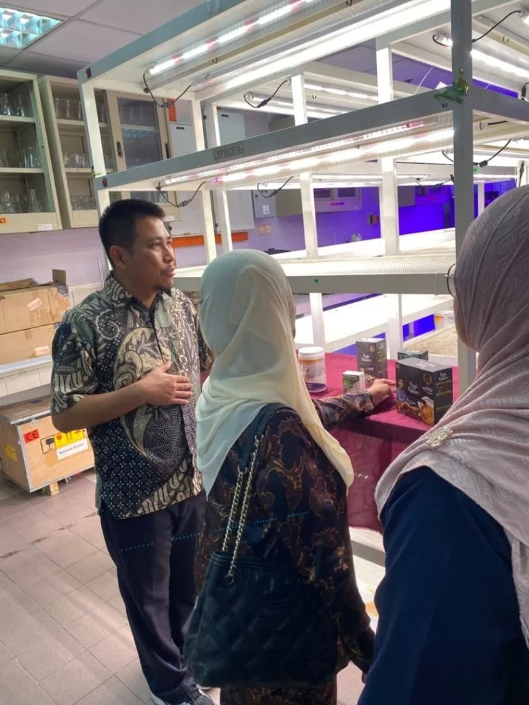 Briefing beside the plant growth racks during the visit to the MIH EMZI NANO-CORE lab